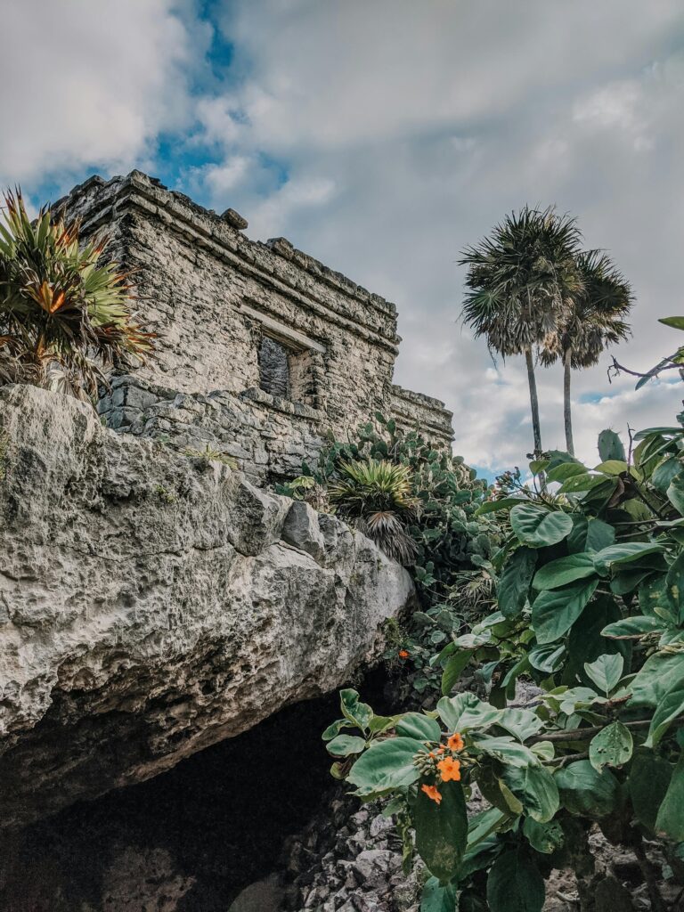 Explore the ancient Mayan ruins surrounded by lush tropical vegetation in Tulum, Mexico.