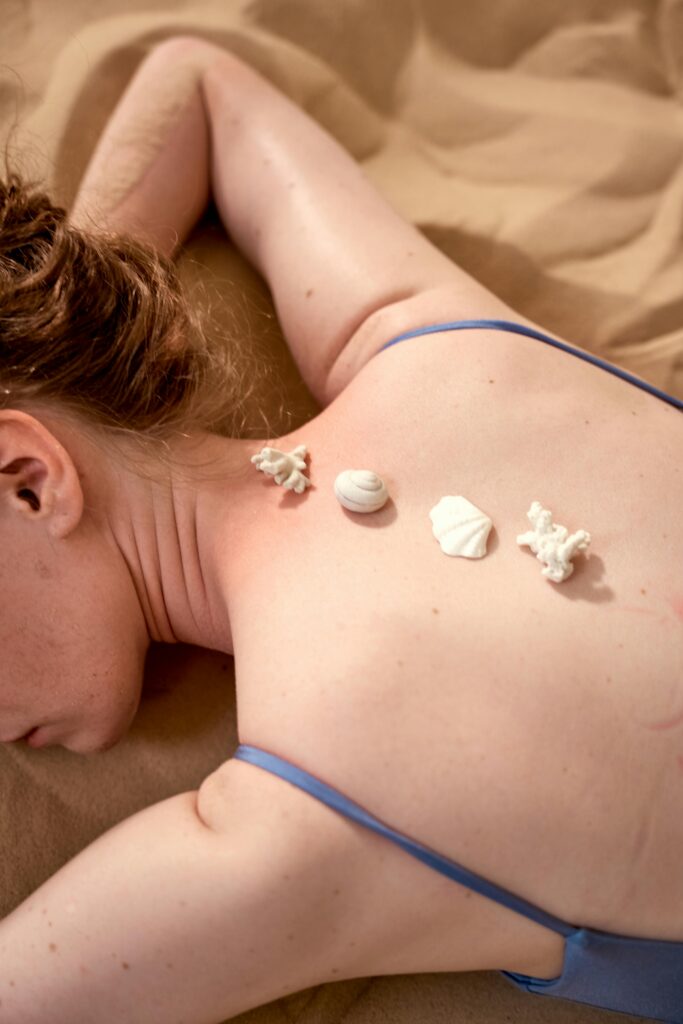 Close-up of seashells on skin in a conceptual spa setting, evoking a sense of relaxation and tranquility.